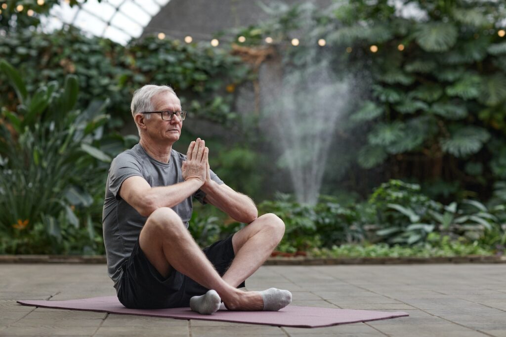 man like many older adults doing yoga